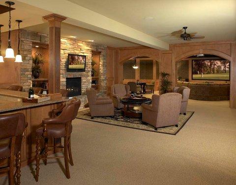 Traditional Basement with stacked stone fireplace surround