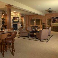 Traditional Basement with stacked stone fireplace surround