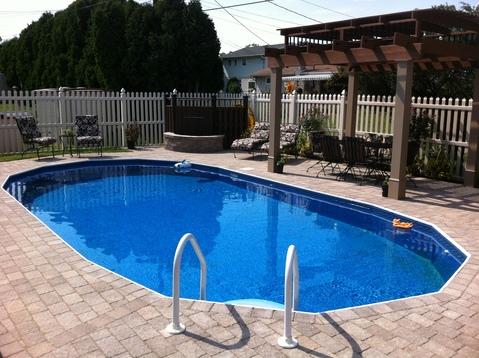 Traditional Pool with brick poolside patio
