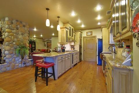 Eclectic Kitchen with hand scraped strip hardwood floor