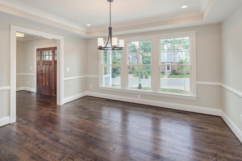 Transitional Dining Room with white recessed ceiling with crown moulding