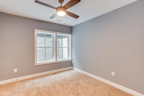 Contemporary Bedroom with large window well lined in brick