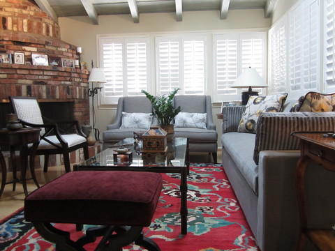Eclectic Family Room with red brick rounded fireplace