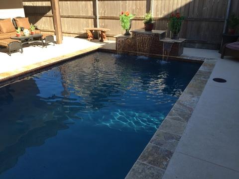 Transitional Pool with rattan cushioned lounge chairs