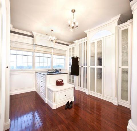 Transitional Closet with textured glass cabinet