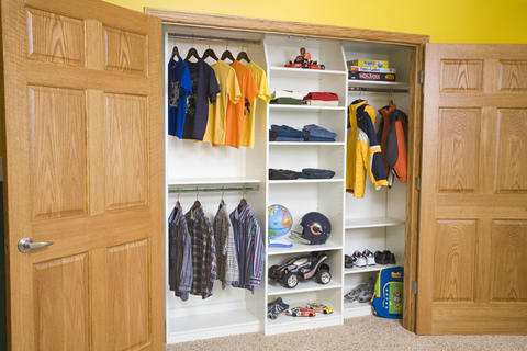 Traditional Closet with beige carpet flooring
