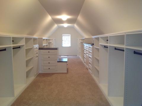 Traditional Closet with beige carpet flooring