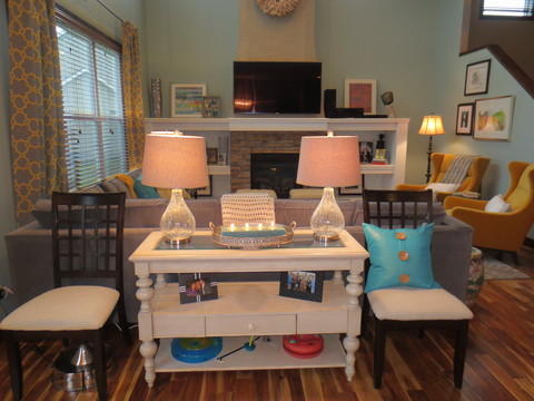 Eclectic Family Room with stacked stone fireplace facing