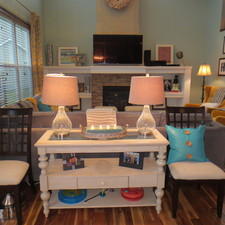Eclectic Family Room with stacked stone fireplace facing