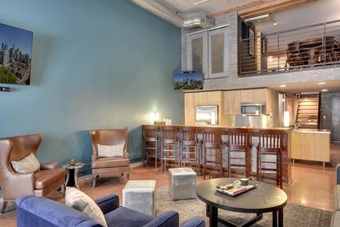 Eclectic Family Room with brown leather wing back chair