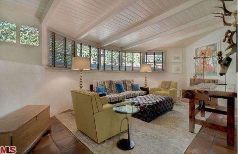 Eclectic Family Room with tongue and groove board ceiling