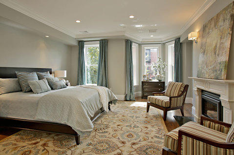 Transitional Bedroom with wood mantel fireplace