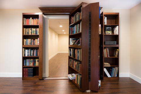 Traditional Home Office with hidden room behind bookcase