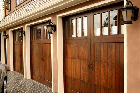 Arts & Crafts Garage with stained wood garage door