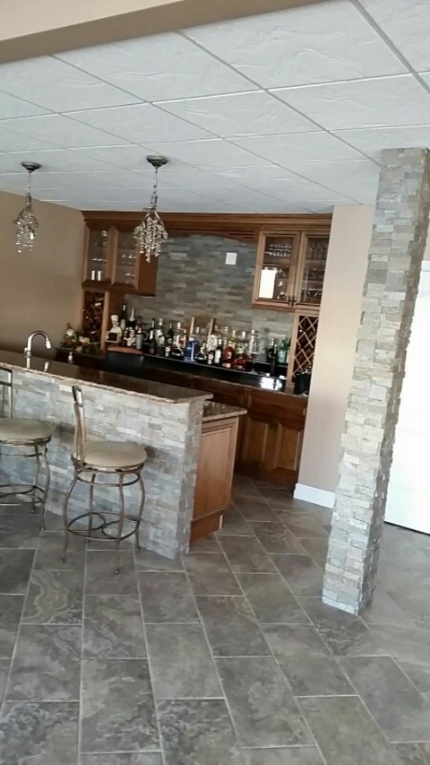 Traditional Basement with tumbled marble tile backsplash