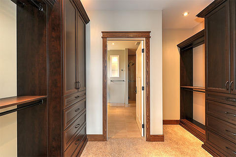 Traditional Closet with beige carpet flooring