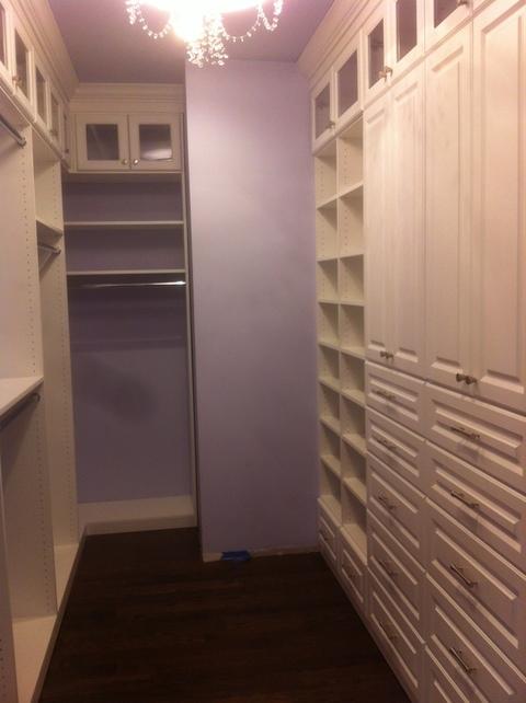Contemporary Closet with glass front cabinets
