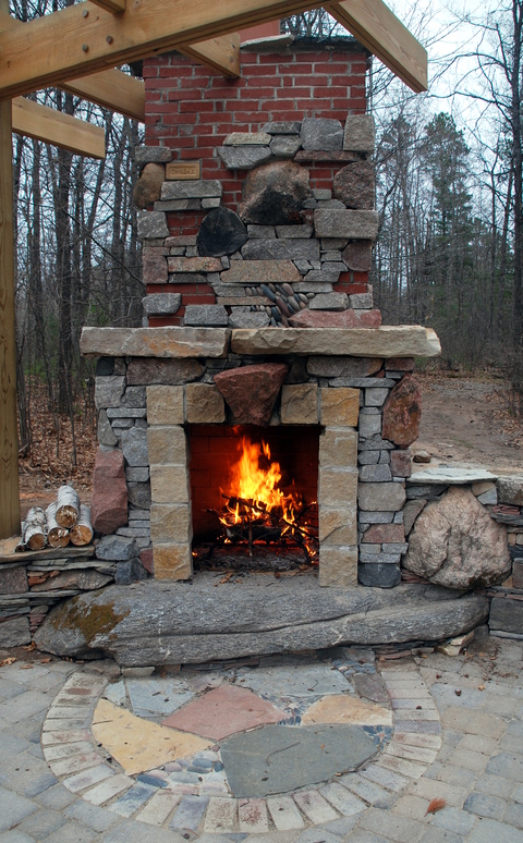Eclectic Patio with stone slab fireplace base