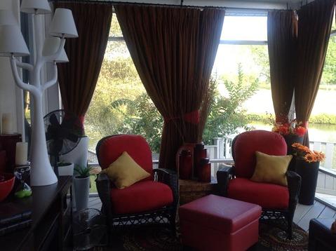 Contemporary Sunroom with wicker chairs with cushions