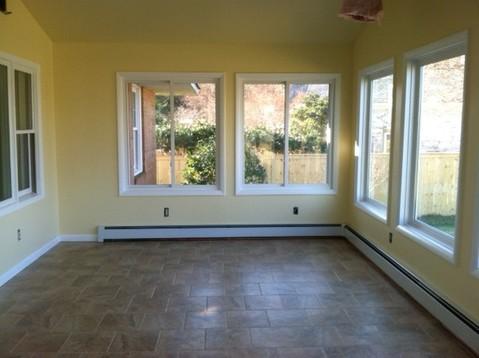 Traditional Sunroom with white baseboard moulding