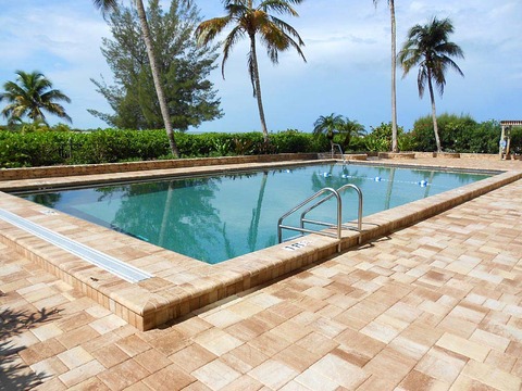 Contemporary Pool with low rock face concrete block wall