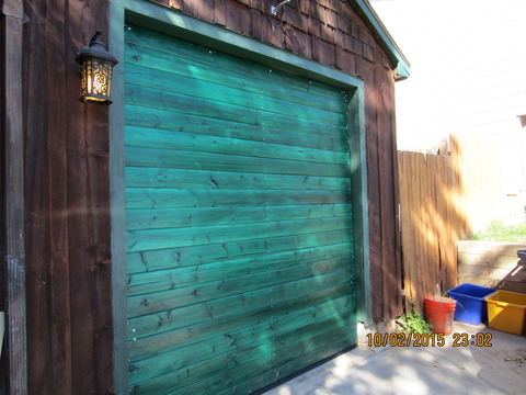 Eclectic Garage with cement paved driveway