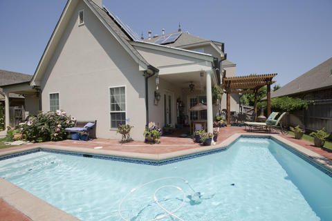 Traditional Pool with stained concrete pool patio