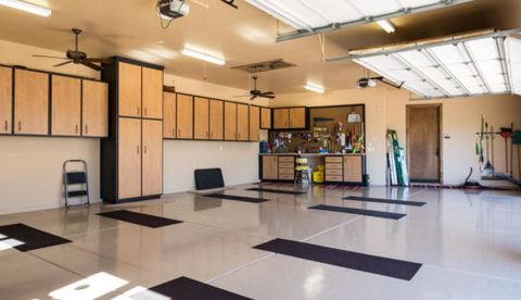 Contemporary Garage with light wood and black cabinets