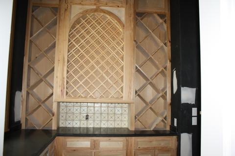 Contemporary Wine Cellar with black solid surface countertop