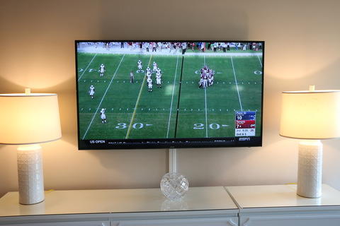 Transitional Bedroom with wall mounted flat screen tv