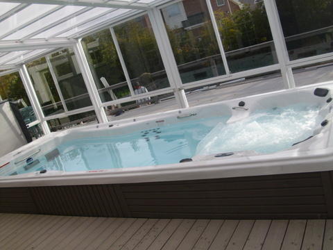 Transitional Sunroom with dark brown paneling on hot tub