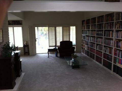 Transitional Library with low profile glass coffee table