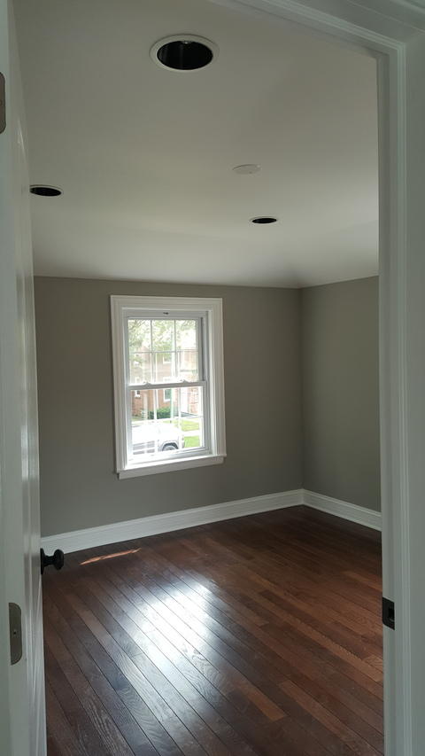 Cape Cod Bedroom with brown walnut hardwood flooring