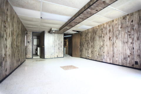 Eclectic Basement with rustic wood panel walls