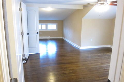 Traditional Bedroom with dark stained hardwood flooring