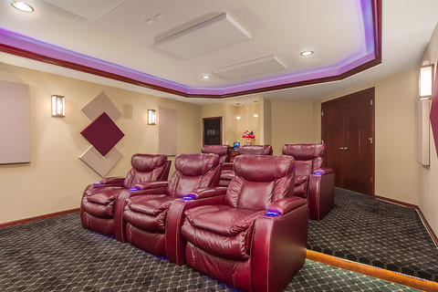 Eclectic Home Theater with red leather theater seats