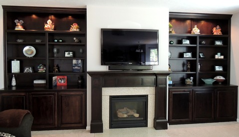 Traditional Family Room with built in cabinets flanking fireplace