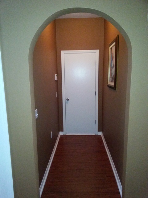 Transitional Entry with dark tan painted walls