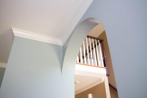 Contemporary Entry with wood handrail and balusters