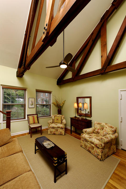 Eclectic Family Room with exposed and stained wood ceiling trusses
