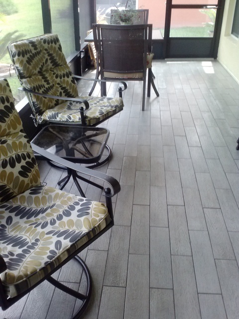 Transitional Sunroom with swivel patio chair