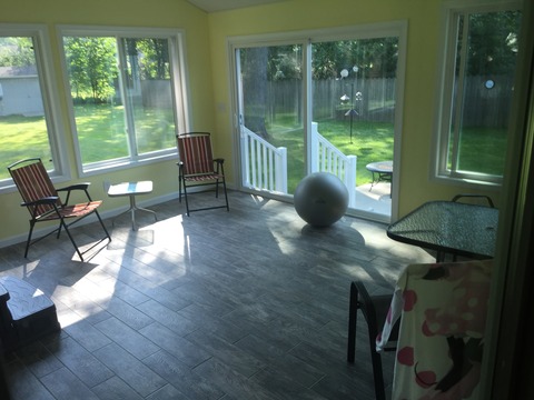 Transitional Sunroom with faux hand scraped plank wood floor