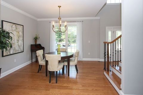 Transitional Dining Room with sheer white tab top curtains