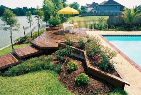 Contemporary Pool with medium wood plank deck