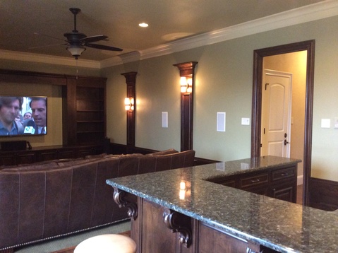 Traditional Home Theater with built in wood shelving and columns