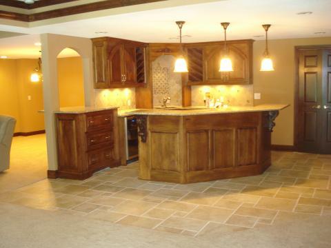 Traditional Basement with medium wood kitchen cabinets