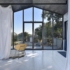 Contemporary Sunroom with white painted plank wood floor