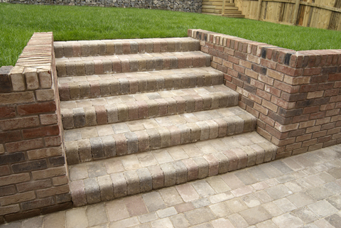 Contemporary Patio with brick retaining wall