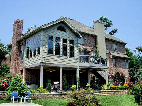 Transitional Sunroom with stone retaining wall