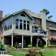 Transitional Sunroom with stone retaining wall